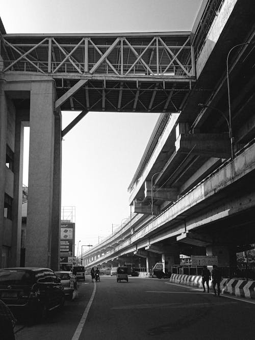 Grayscale Photo of Vehicles on City Road