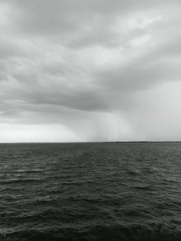 Black and white seascape of Chennai with dramatic skies and sea horizon.