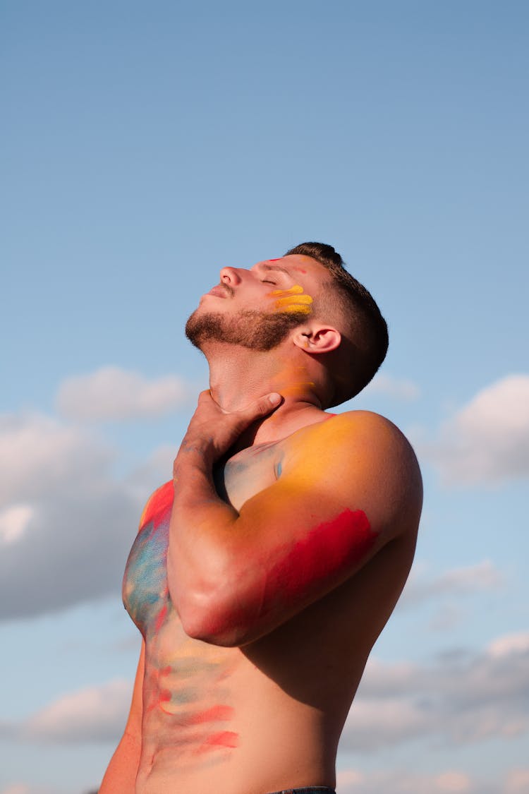 A Shirtless Man With Paint On His Body