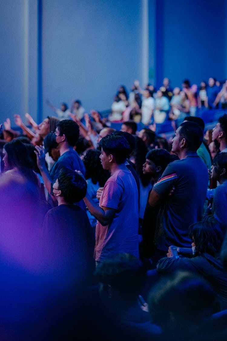 People Standing In An Audience 