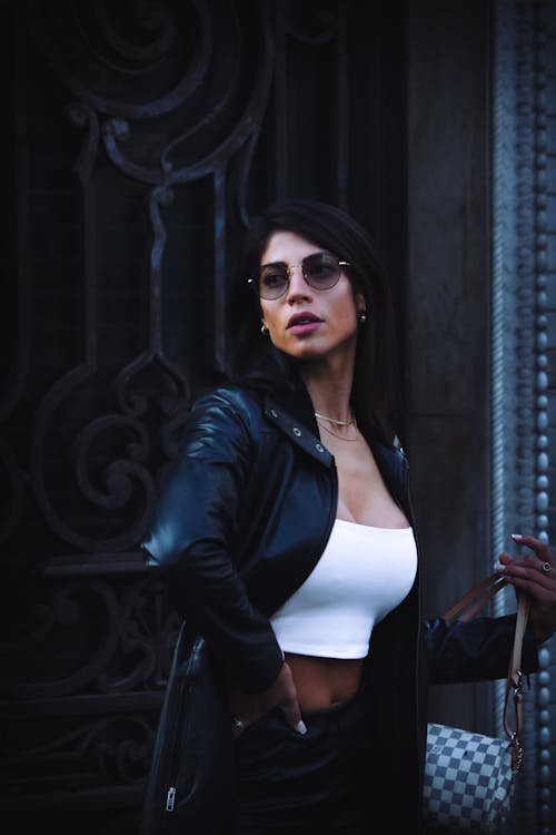 A Woman in Black Leather Jacket Wearing Sunglasses
