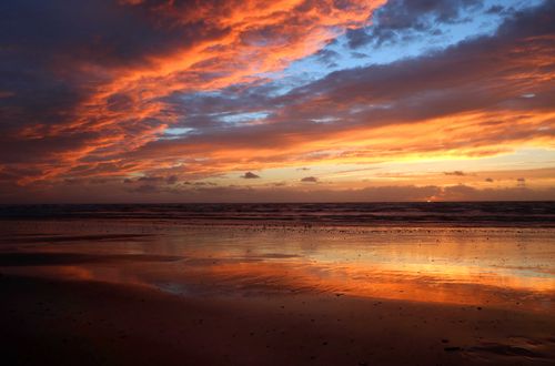 Free Vibrant sunset with dramatic clouds over Saint-Pair-sur-Mer beach, Normandie, capturing tranquility and nature's beauty. Stock Photo