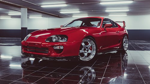 Red Toyota Supra Parked at a Garage