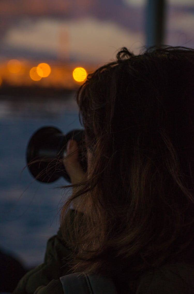 Back Of The Head Of A Woman Taking Photos