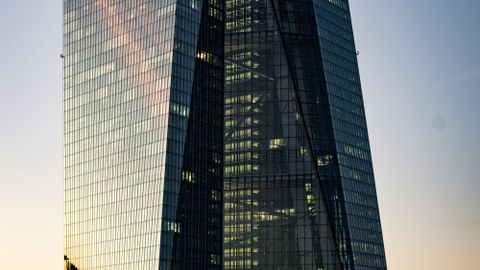 Low-angle shot of the ECB Tower in Frankfurt at sunset capturing an urban skyline.