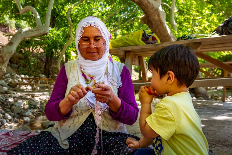 Child Watching His Grandmother Crocheting