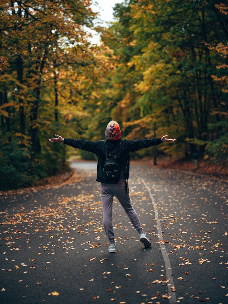 Woman Enjoying Walk In Autumn Park