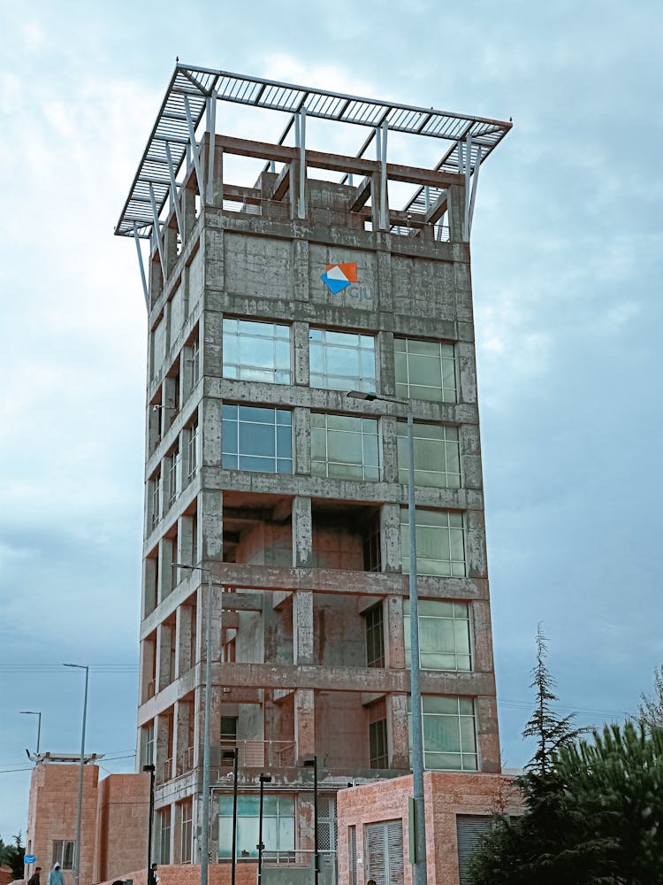 Gray Unfinished Building Under Blue Sky