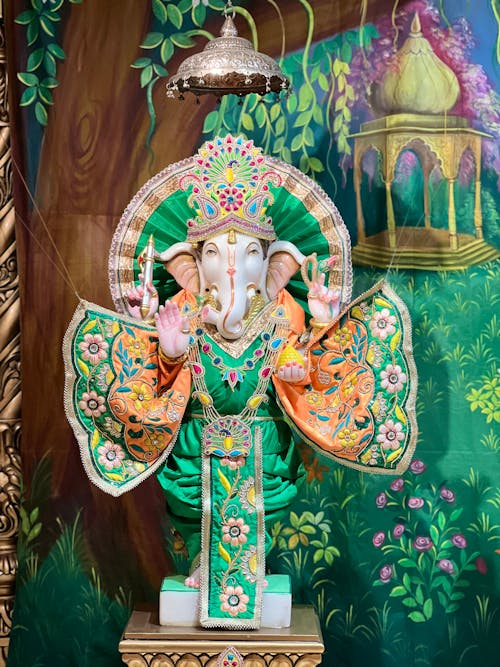 A Ganesh Statue Dress in Green Clothing with Floral Design