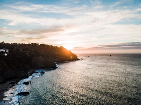 Breathtaking aerial view of San Francisco's coastline at sunset with dramatic skies.