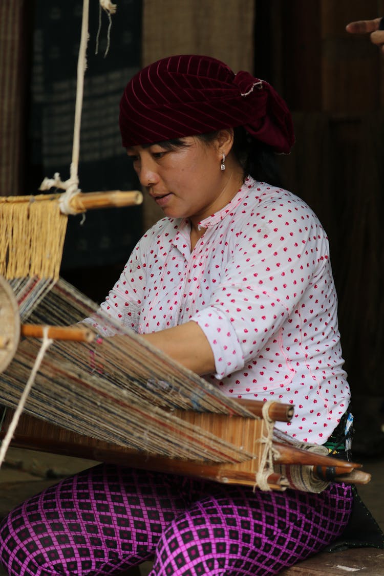 A Woman Wearing Headscarf Weaving