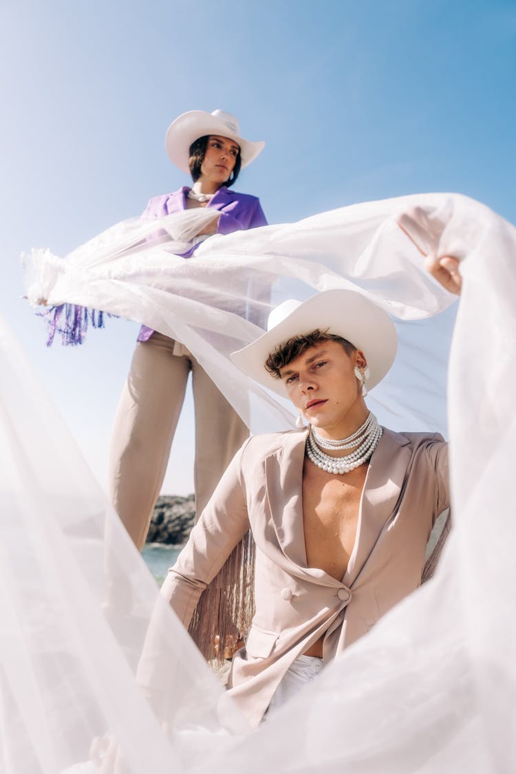 Couple Posing With Tulle On Blue Sky Background 