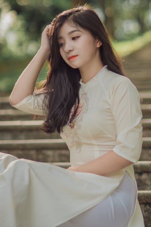 Photography of Woman Sitting on Stairs