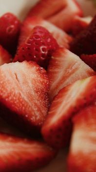 A detailed close-up of fresh, ripe sliced strawberries showcasing their juicy texture and vibrant red color.