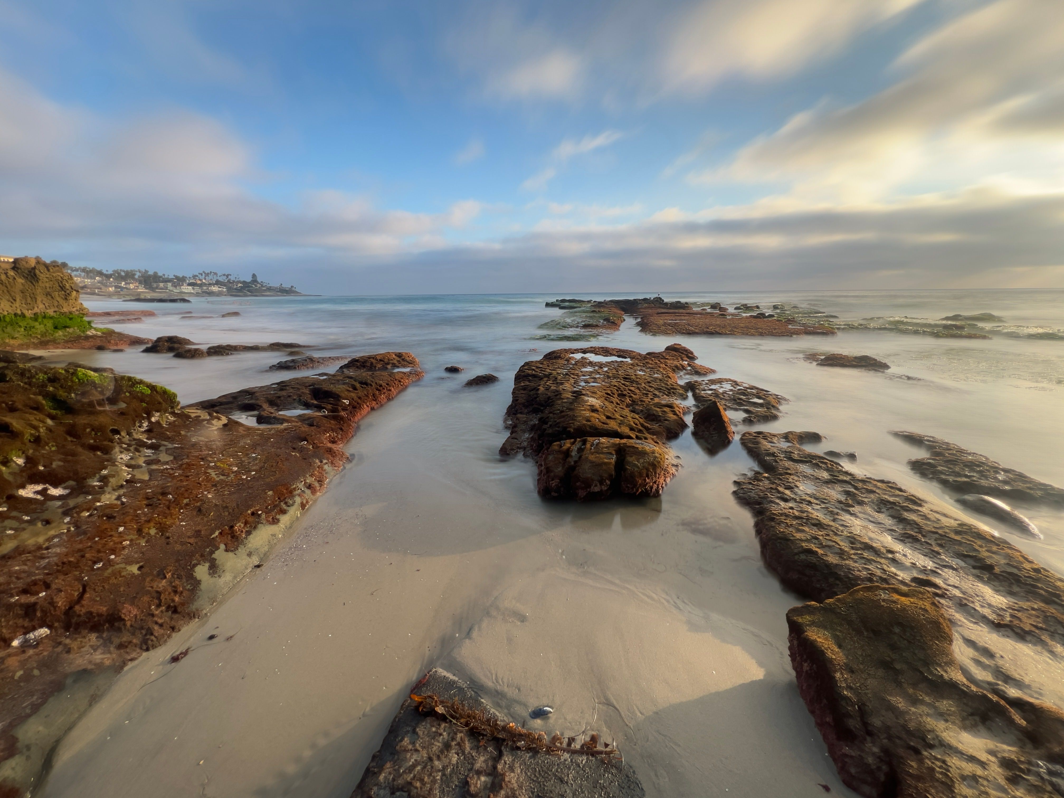 A Rock Formations on the Beach Under the Cloudy Sky · Free Stock Photo