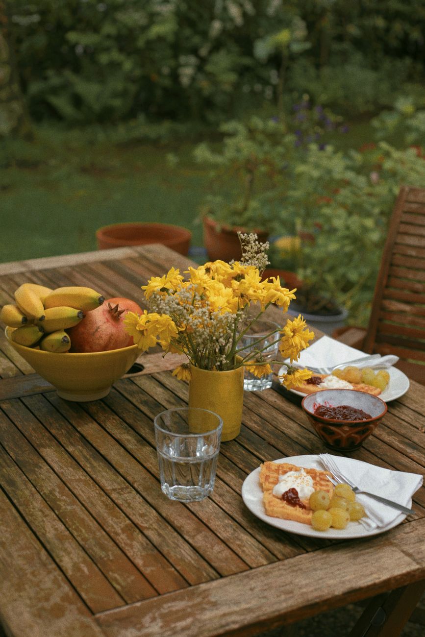 Breakfast table in the garden with sea in distance