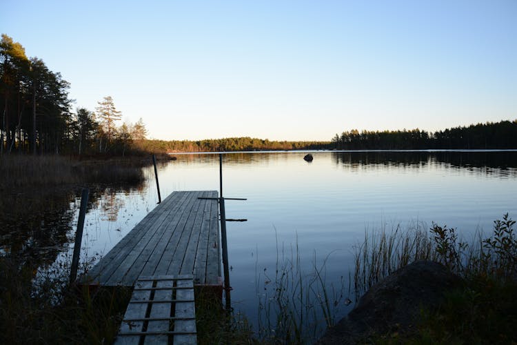 Wooden Dock On Calm Lake 