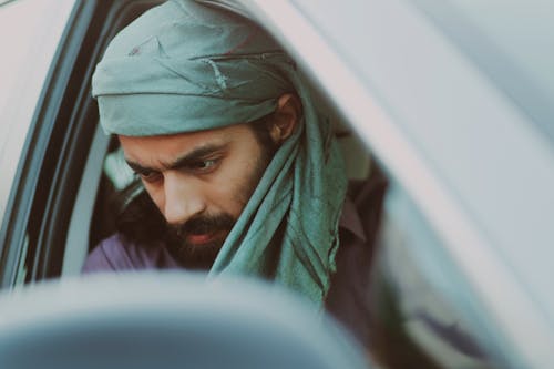 Bearded Man in the Car Wearing Green Headscarf