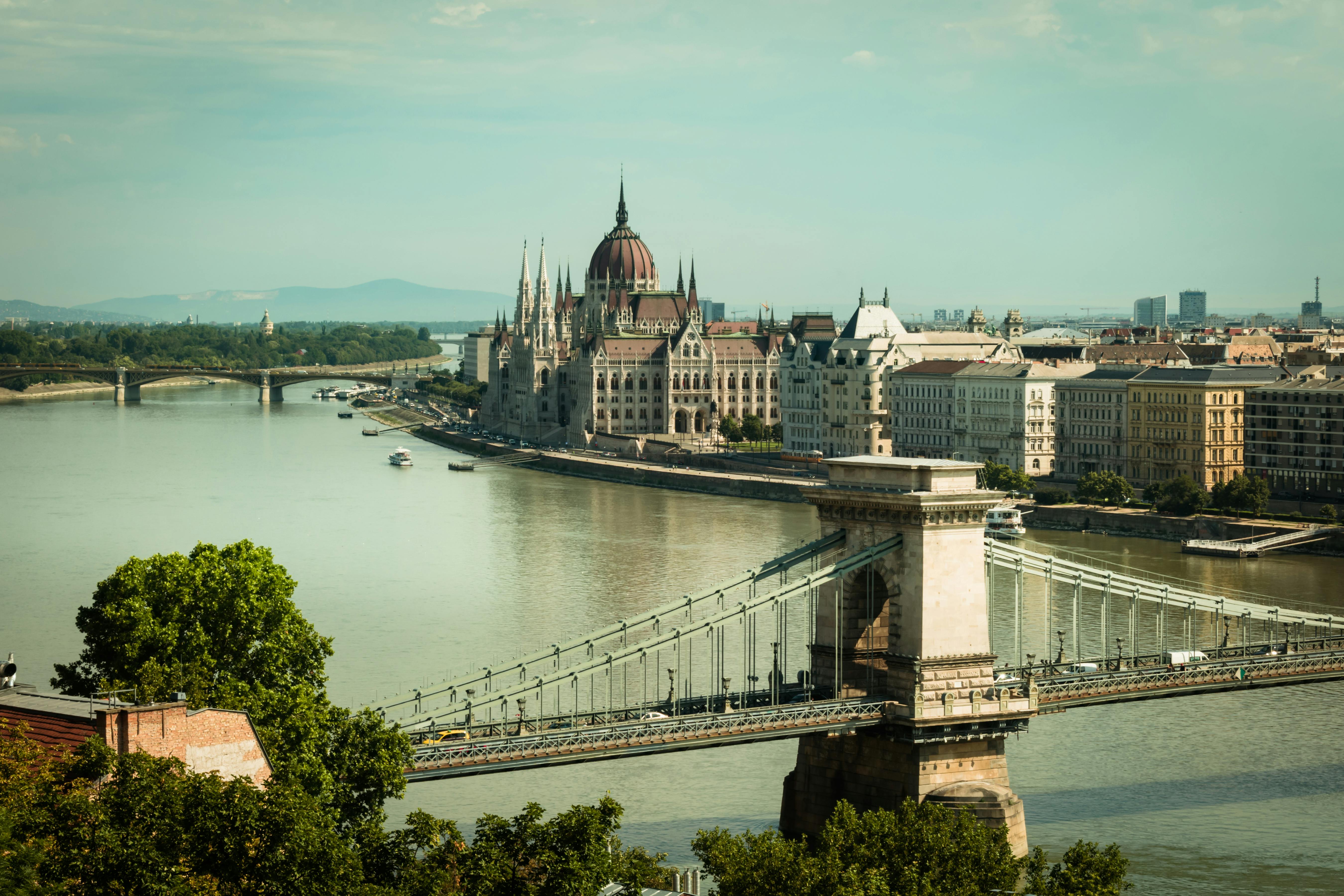 bridge over river near city buildings