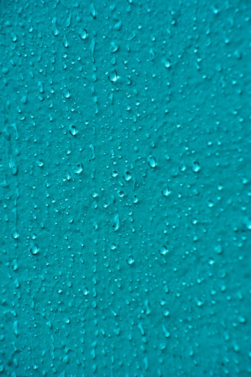 Close-up of Water Drops on a Blue Surface 