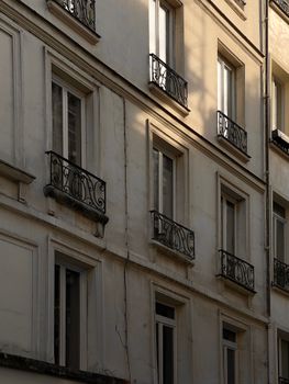 Charming urban facade showcasing classic architectural design with ornate iron balconies.