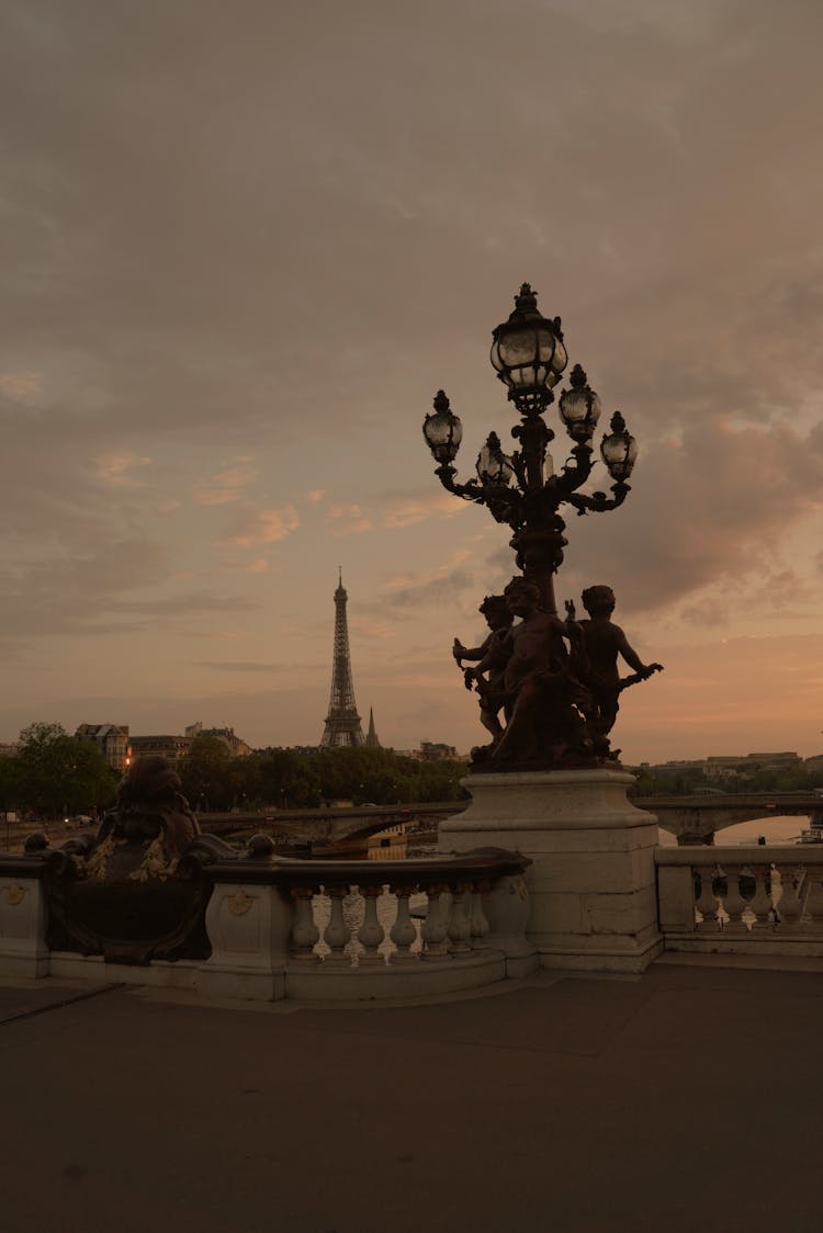 Sculpture And Streetlight Near Eiffel Tower In Paris, France