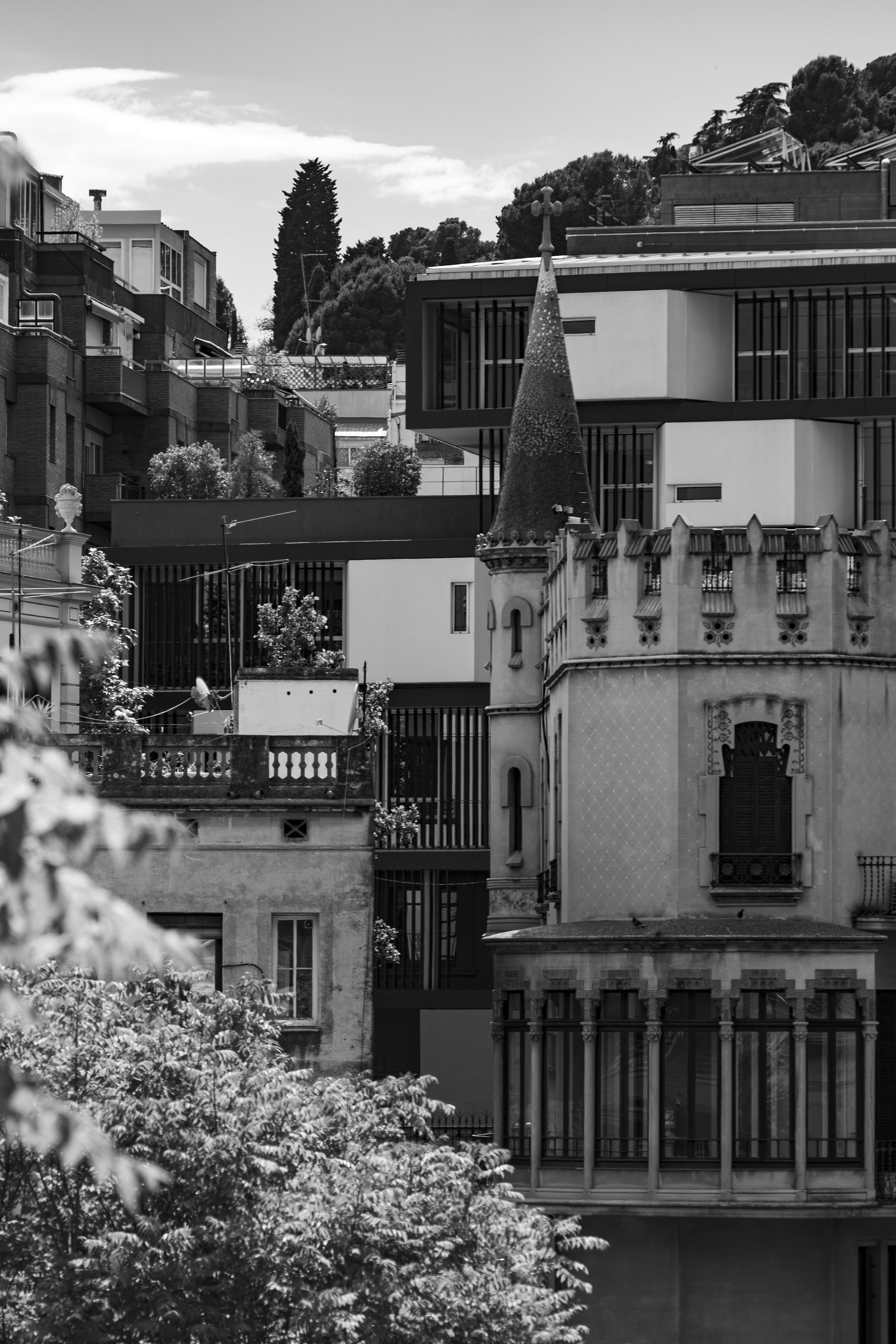 A dramatic black and white cityscape featuring gothic architecture and modern buildings.
