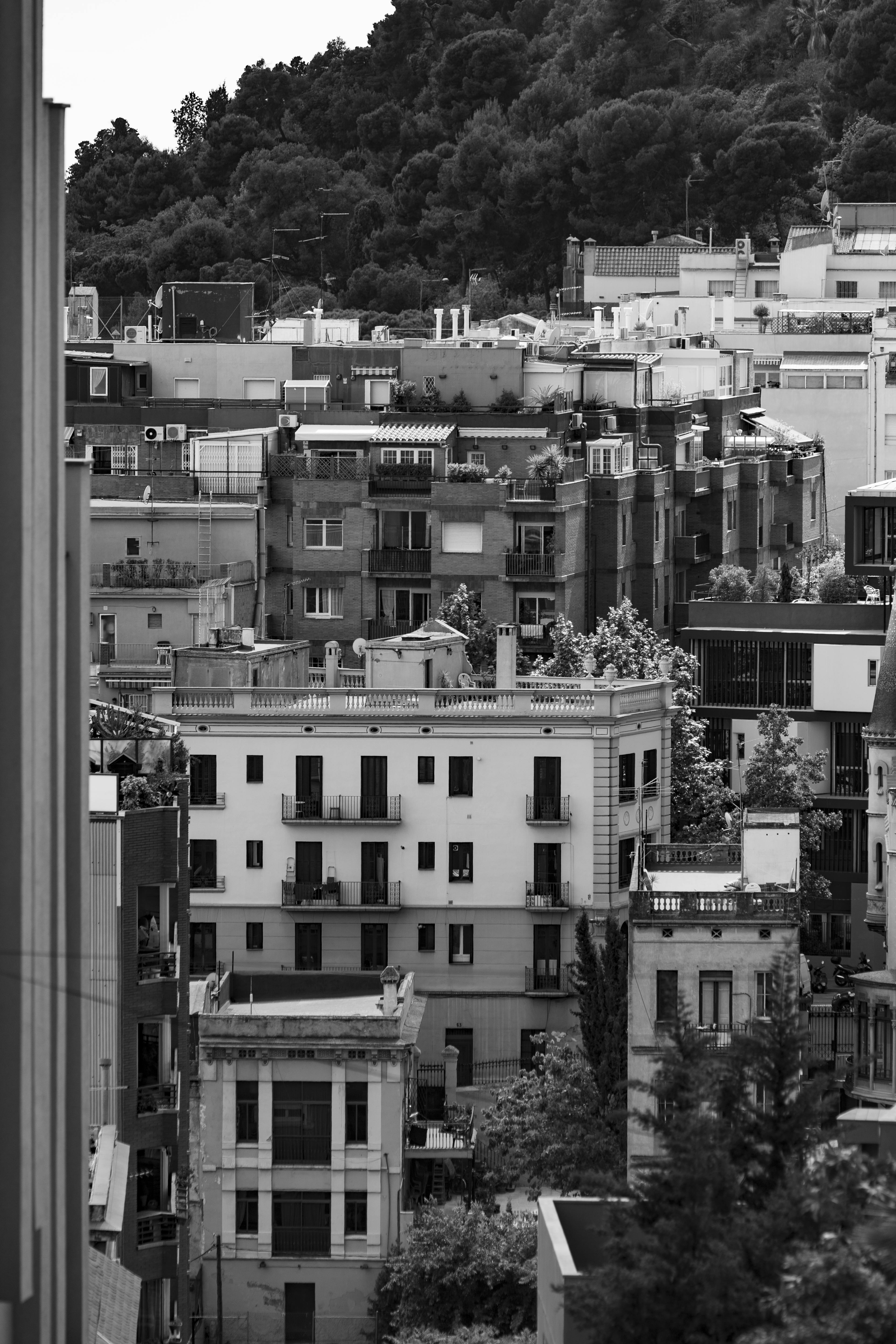 Grayscale photo of Spanish urban architecture showcasing several residential buildings.
