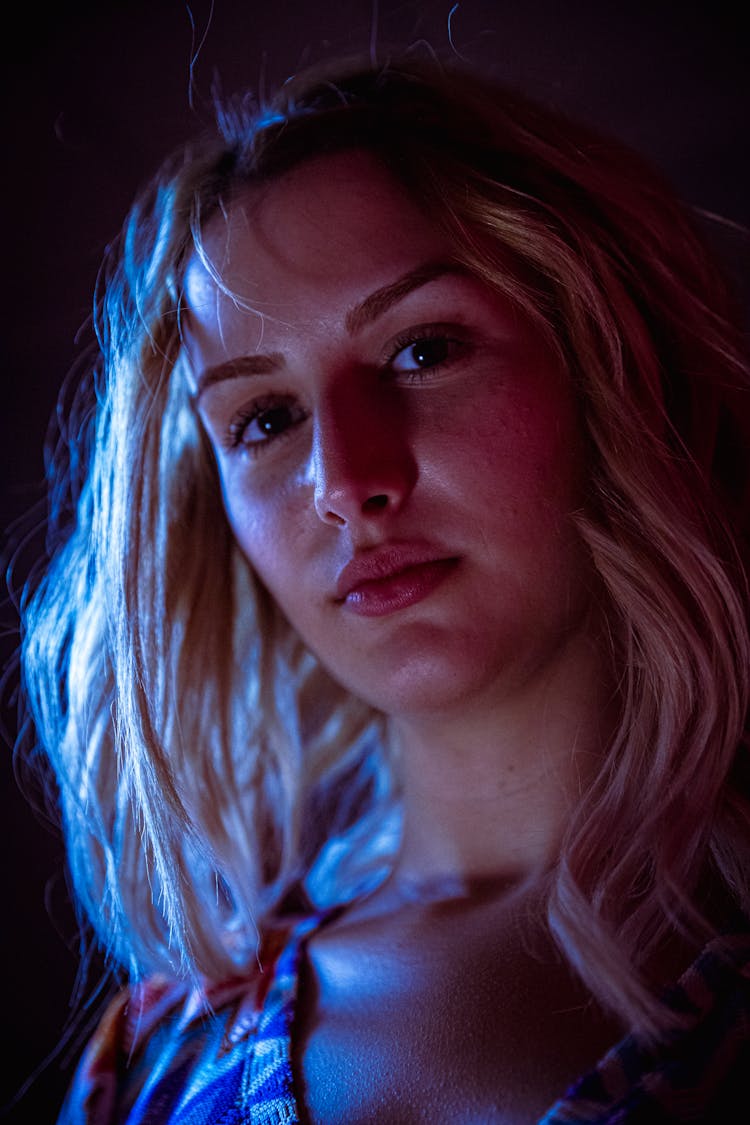 Low Angle Shot Of A Beautiful Woman With Blonde Hair Looking At The Camera