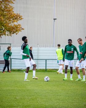 Players practice soccer on a sunny day in Lommel, Belgium. Captured with Canon EOS 90D.