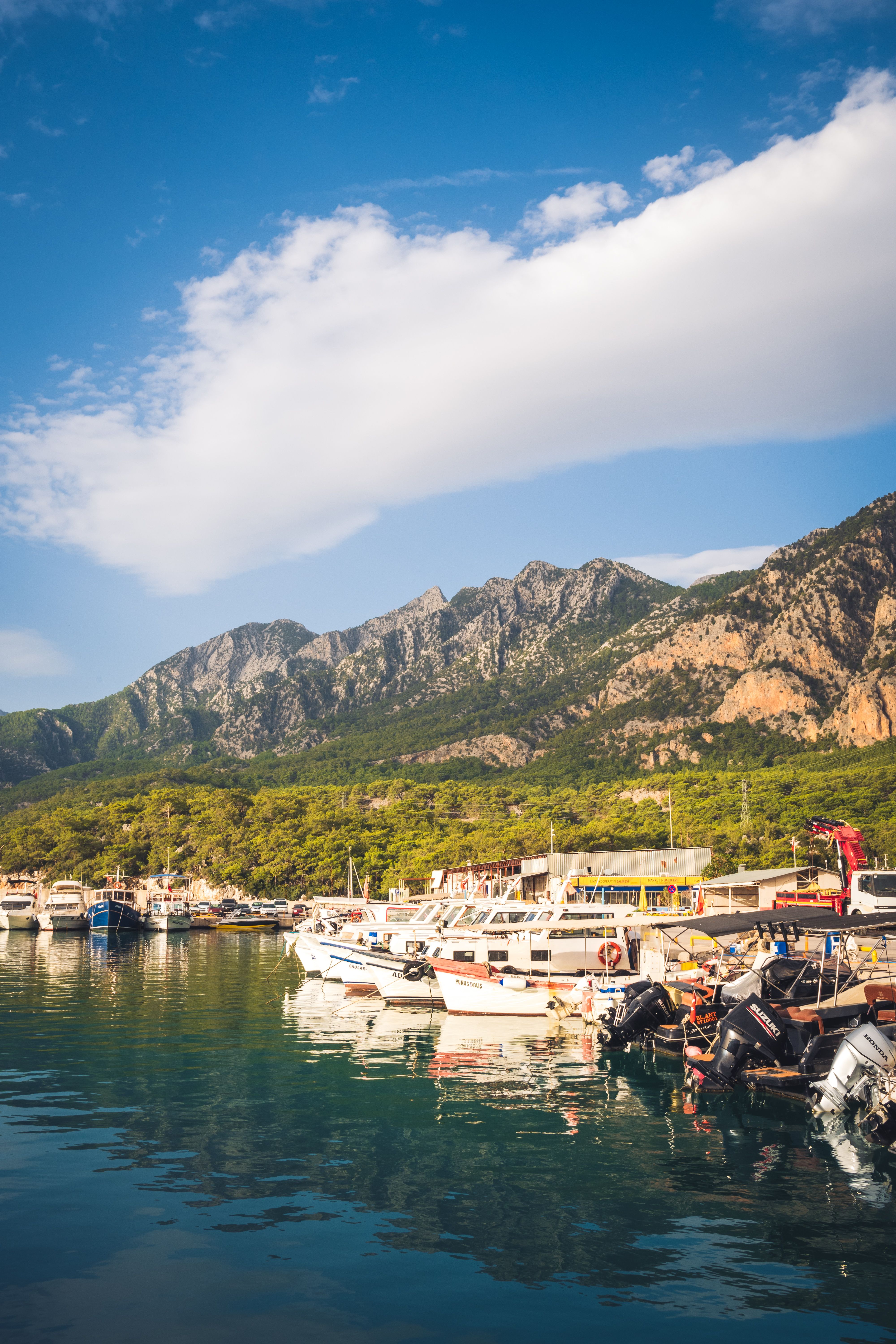 Boats Moored on the Shore and Mountains in the Background · Free Stock ...