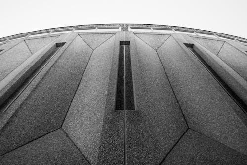 Grayscale Photo of a Concrete Building in  Low Angle Shot