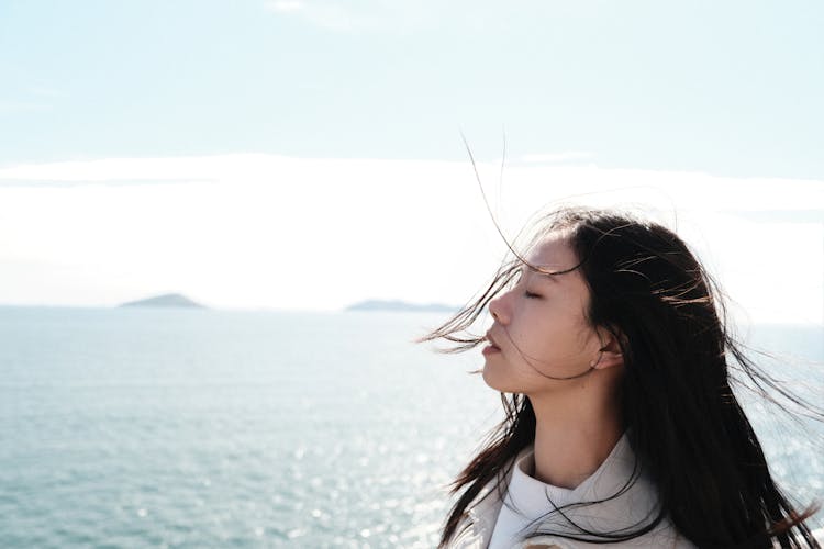 Woman Enjoying Sea Breeze