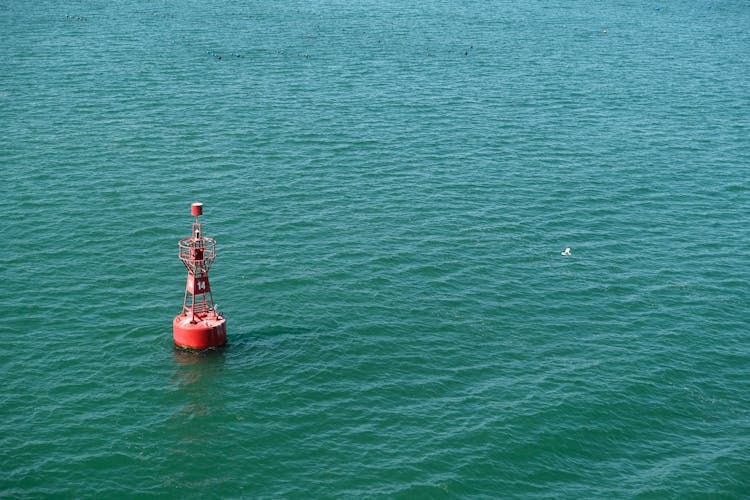 Red Buoy Floating On Sea