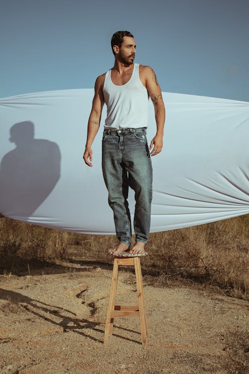 A Man Standing on Wooden Stool