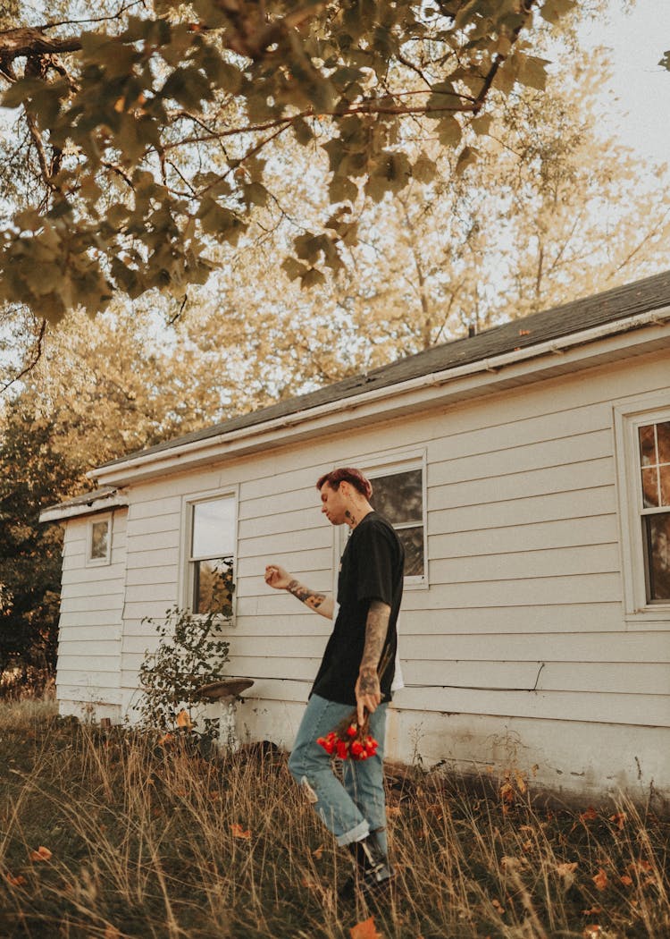 A Man Walking At The Backyard