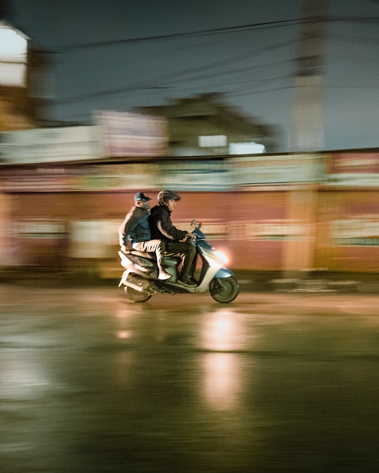 Men Riding A Motorcycle In Duo