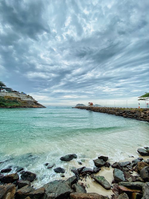 Photo of Rocky Shore Under Cloudy Sky