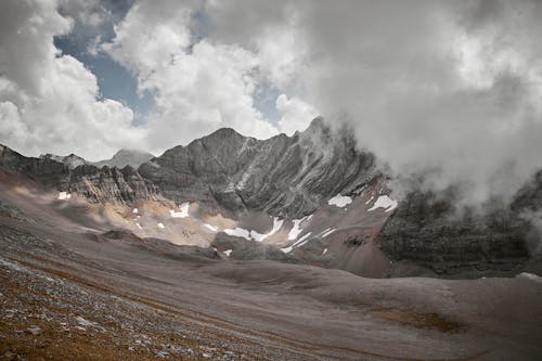 Free A Rocky Mountain Under Cloudy Sky Stock Photo