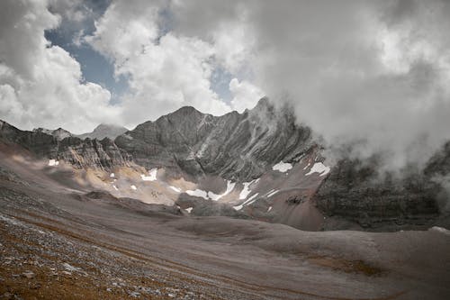 A Rocky Mountain Under Cloudy Sky