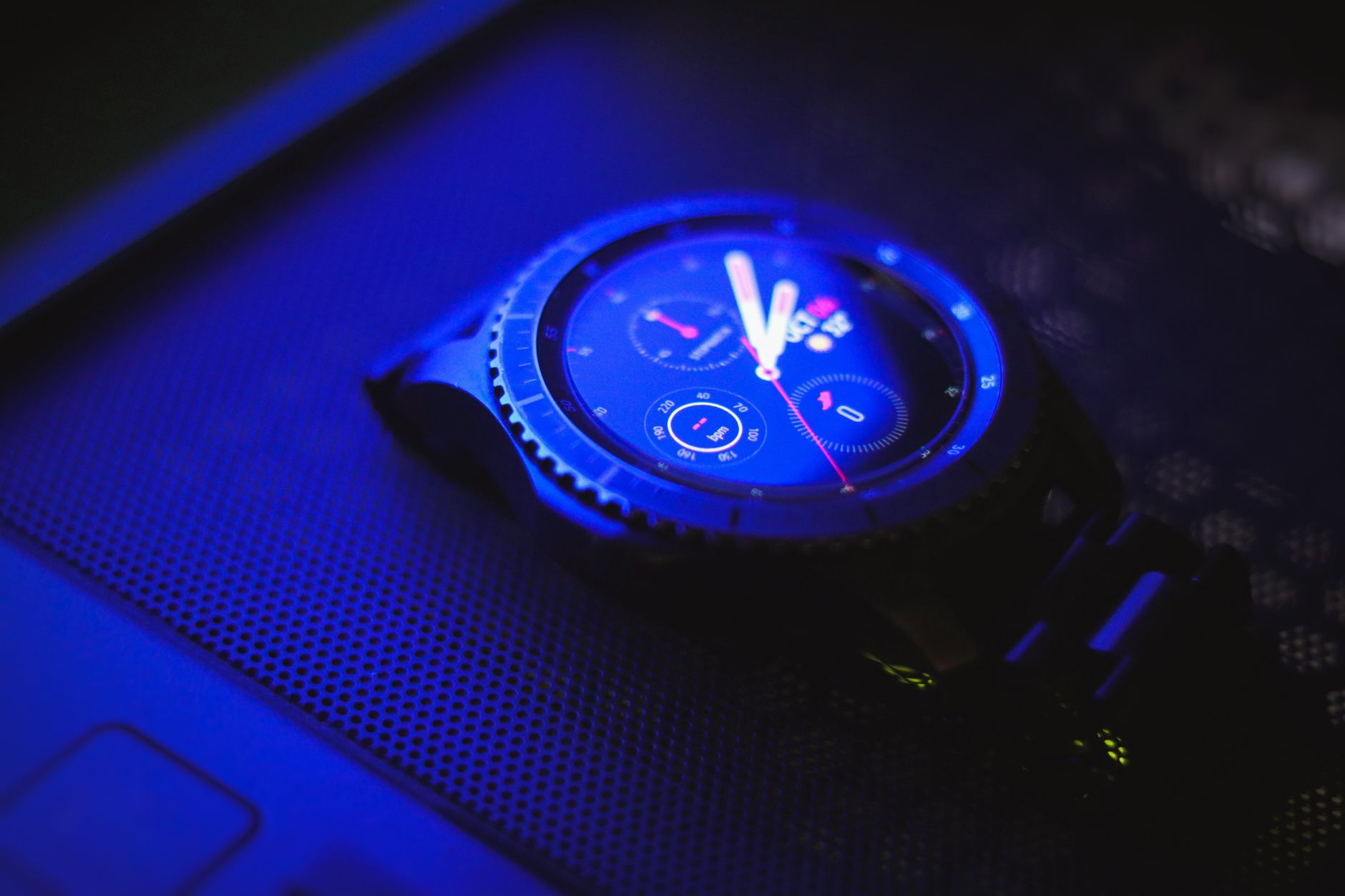 A sleek digital wristwatch illuminated by blue light, showcasing time with precision.