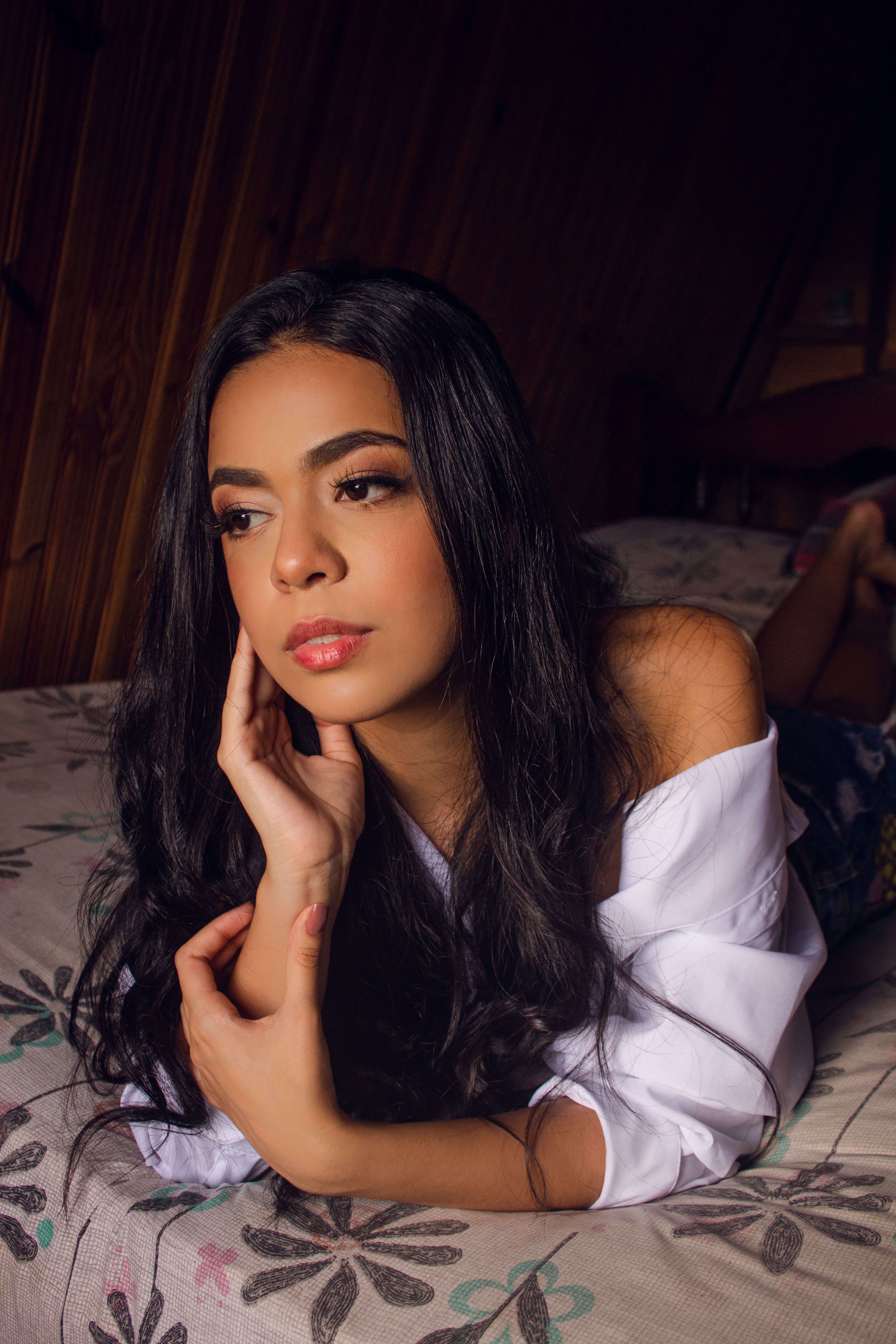 Woman in White Long Sleeve Shirt Lying on Bed · Free Stock Photo