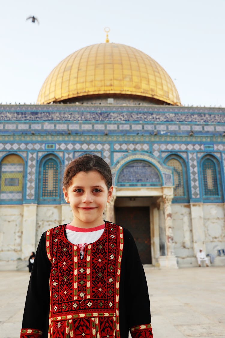 Child In Traditional Clothing In Front Of The Dome Of The Rock In Jerusalem 