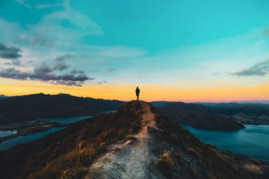 Person Standing on Brown Rock Formation