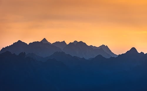 Silhouette of Mountains During Sunset