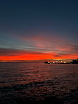 Beautiful sunset over the Adriatic Sea in Durrës, Albania, showcasing vibrant red and orange hues.