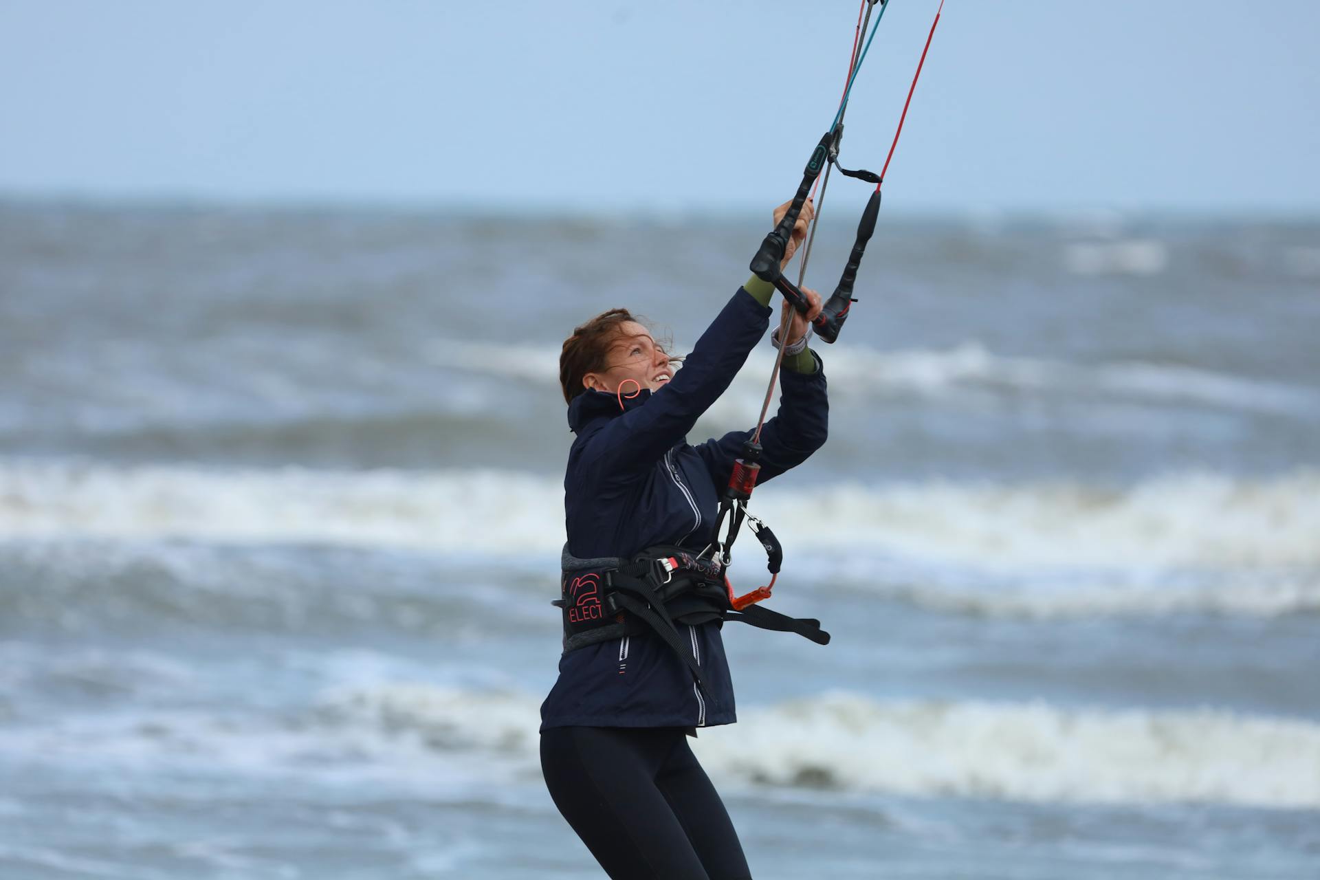 Man in Black Jacket and Harness Holding on a Rope