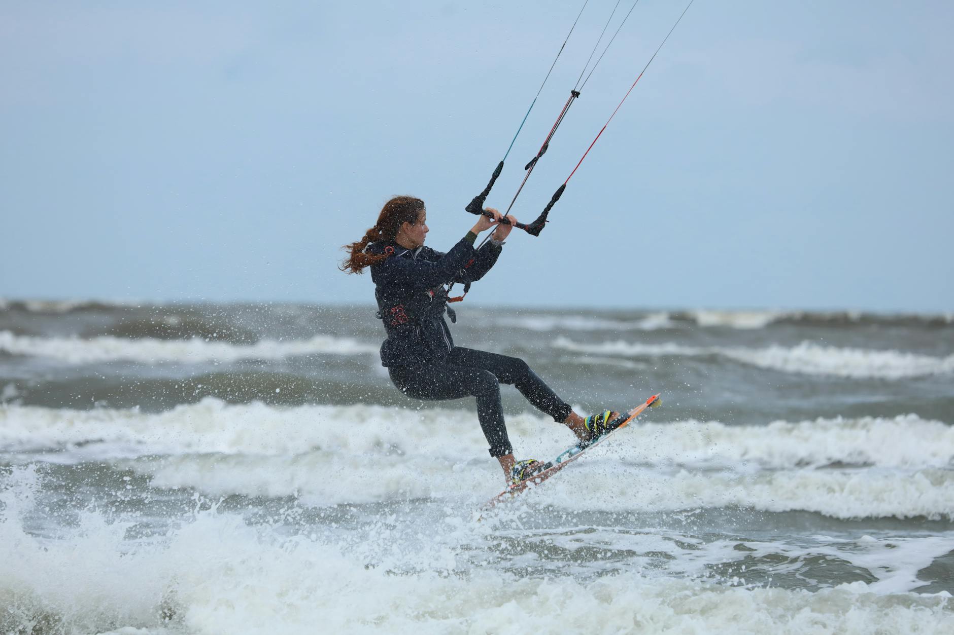 A Woman Enjoys Kite Boarding 