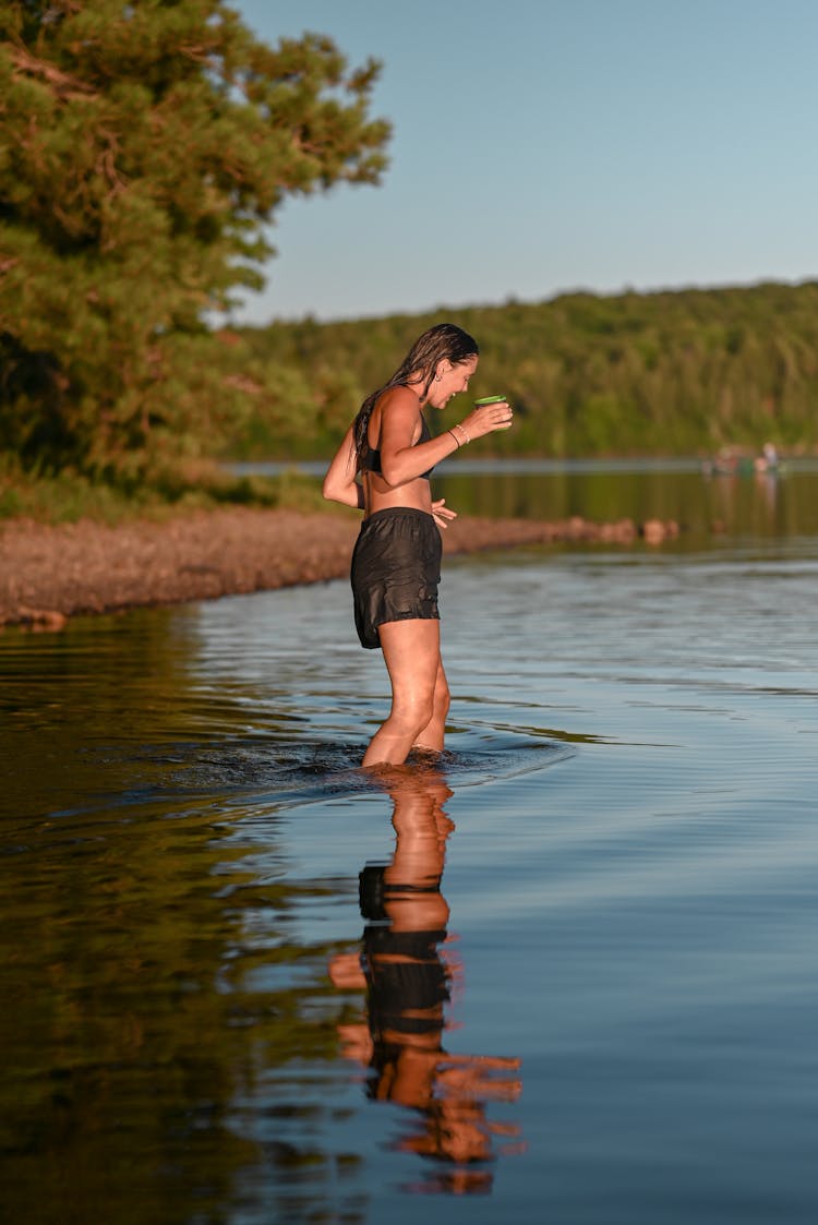 A Woman Swimming In The Lake