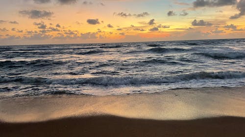 Sea Waves Crashing on Shore during Sunset